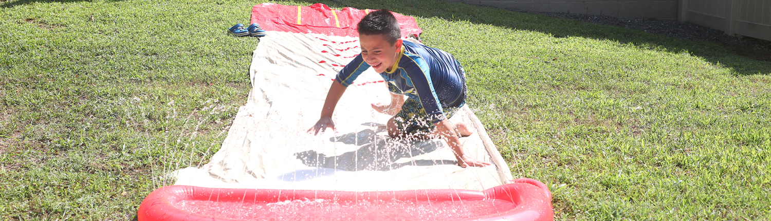 Applied Behavior Analysis client plays on slip and slide