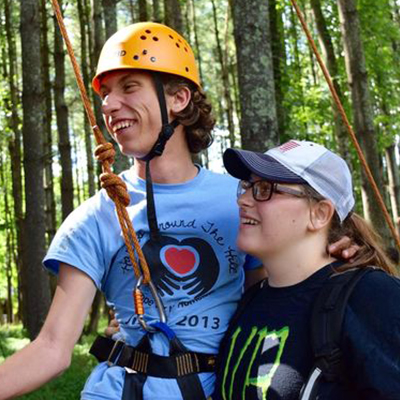 Campers smiling in woods at Camp Easterseals UCP