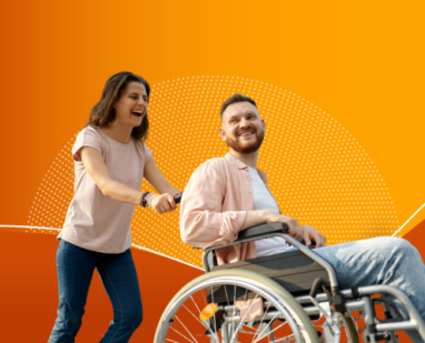 A man in wheelchair walking with a woman and laughing together