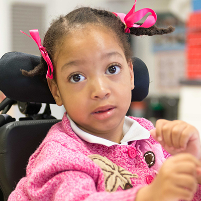 Little girl in wheelchair smiling