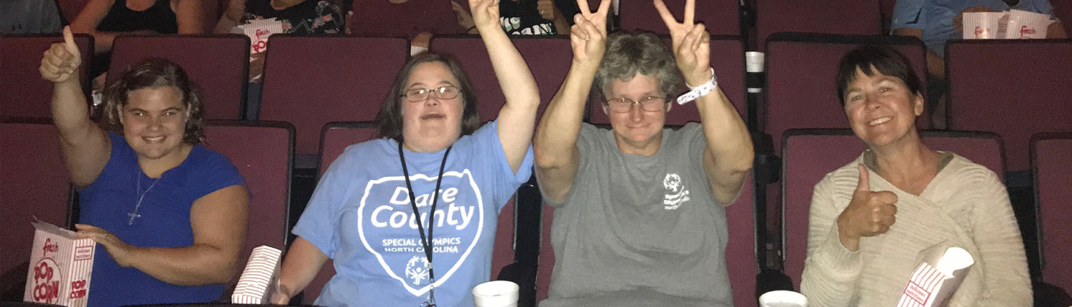 Individual and Community Service clients smiling at a movie