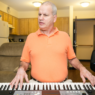 Man playing piano receives mental health services