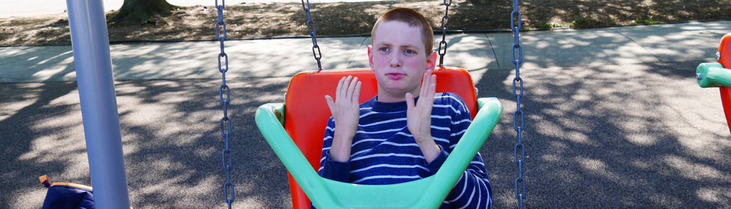 Boy with Cerebral palsy on swing