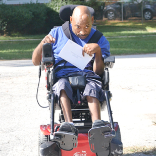 Man in wheelchair using assistive technology