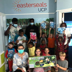 Easterseals UCP children smiling with donations from fundraiser