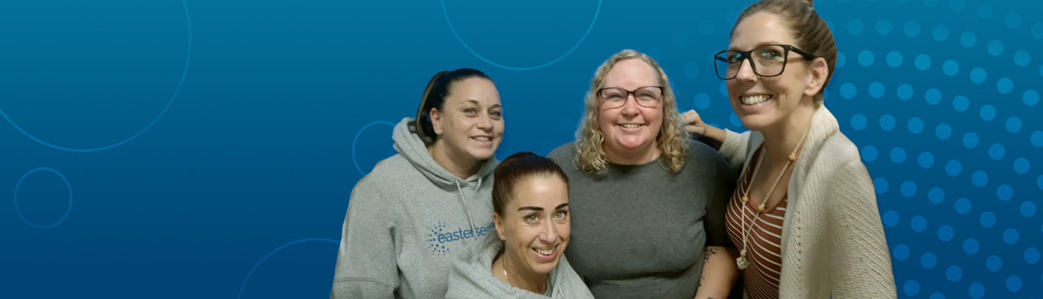 Multisystemic Therapy team members smiling blue background