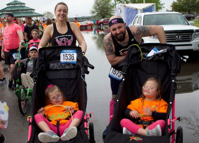 Family running with disabled children at Glow Run New Bern event
