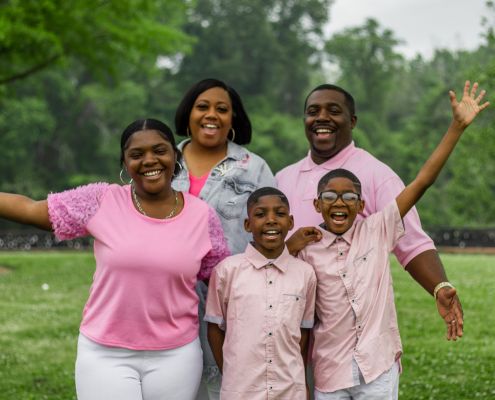Easterseals UCP foster family smiling in pink shirts